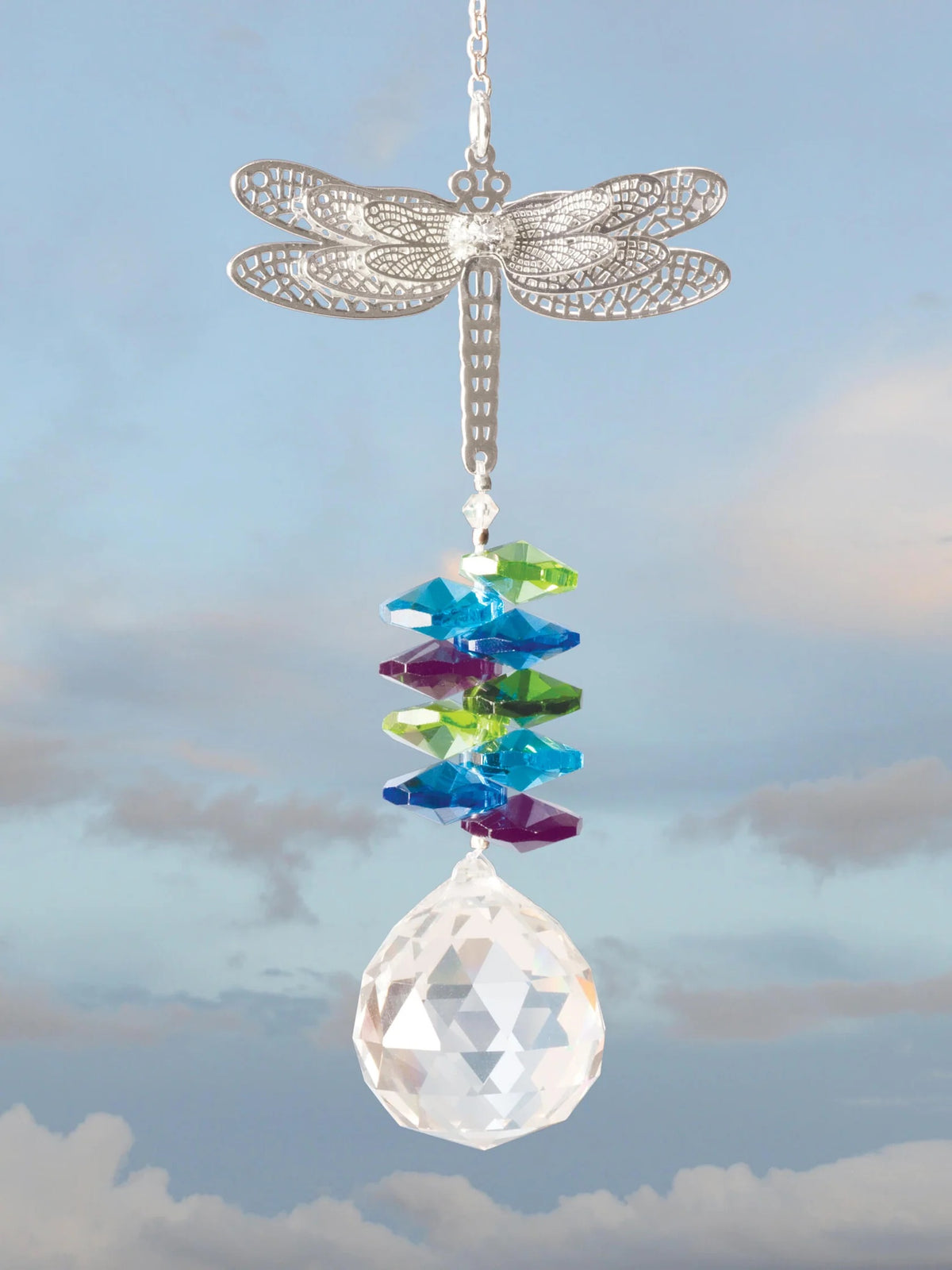 Finished dragonfly crystal suncatcher hanging against a blue sky with a faceted crystal drop